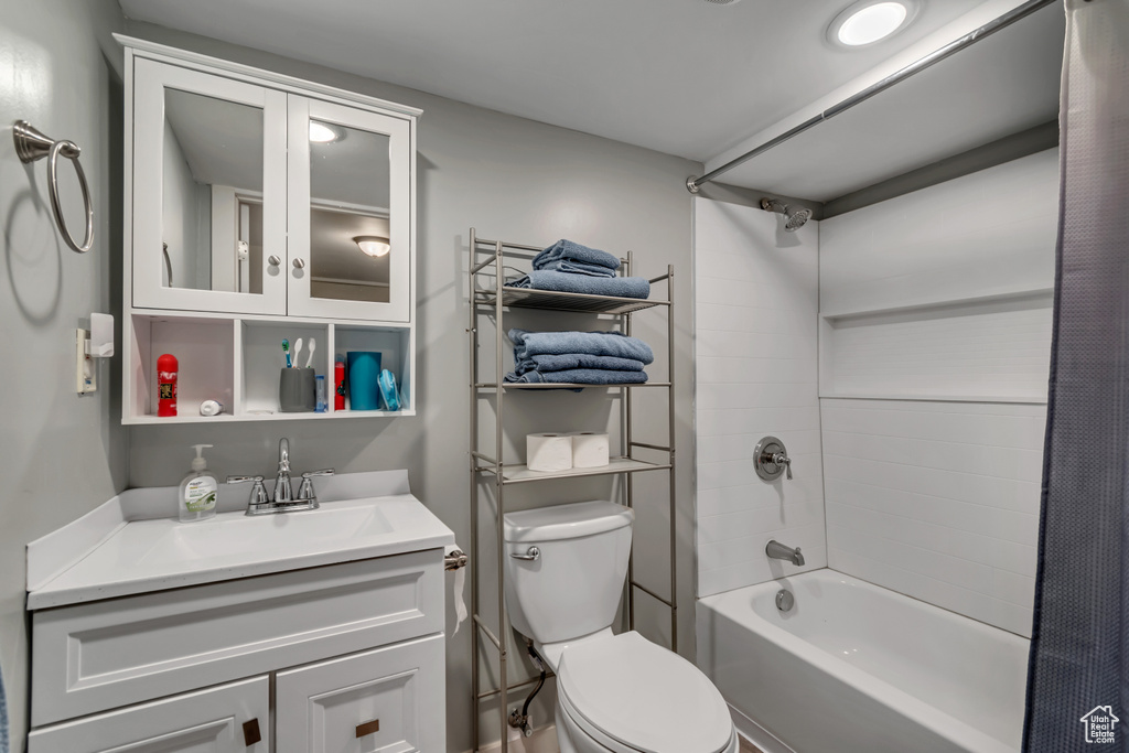 Bathroom with vanity, bathtub / shower combination, and toilet