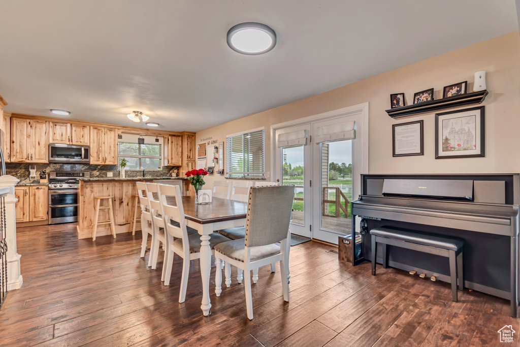 Dining area featuring dark wood-type flooring