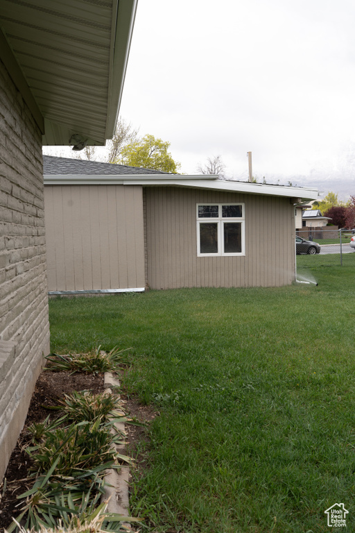 View of side of property with a yard