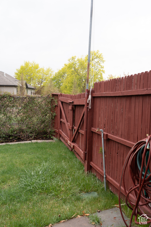 View of yard with fence and a gate