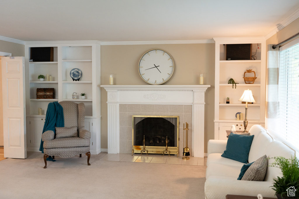 Carpeted living area featuring built in features, ornamental molding, and a fireplace