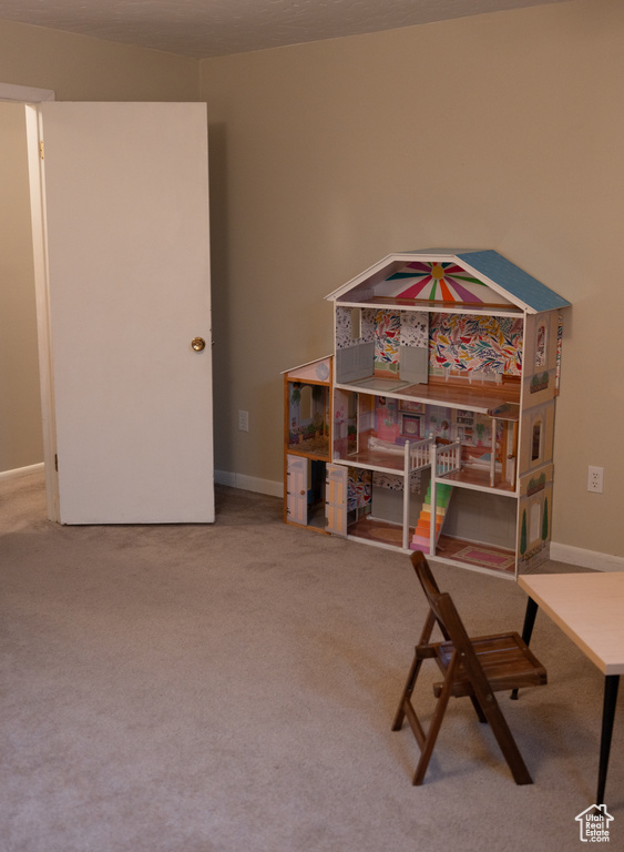 Home office with baseboards and carpet