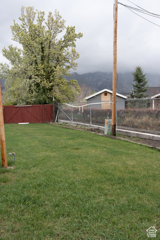 View of yard featuring a fenced backyard and a mountain view