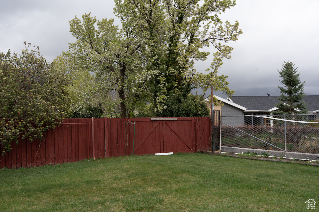 View of yard with fence and a gate