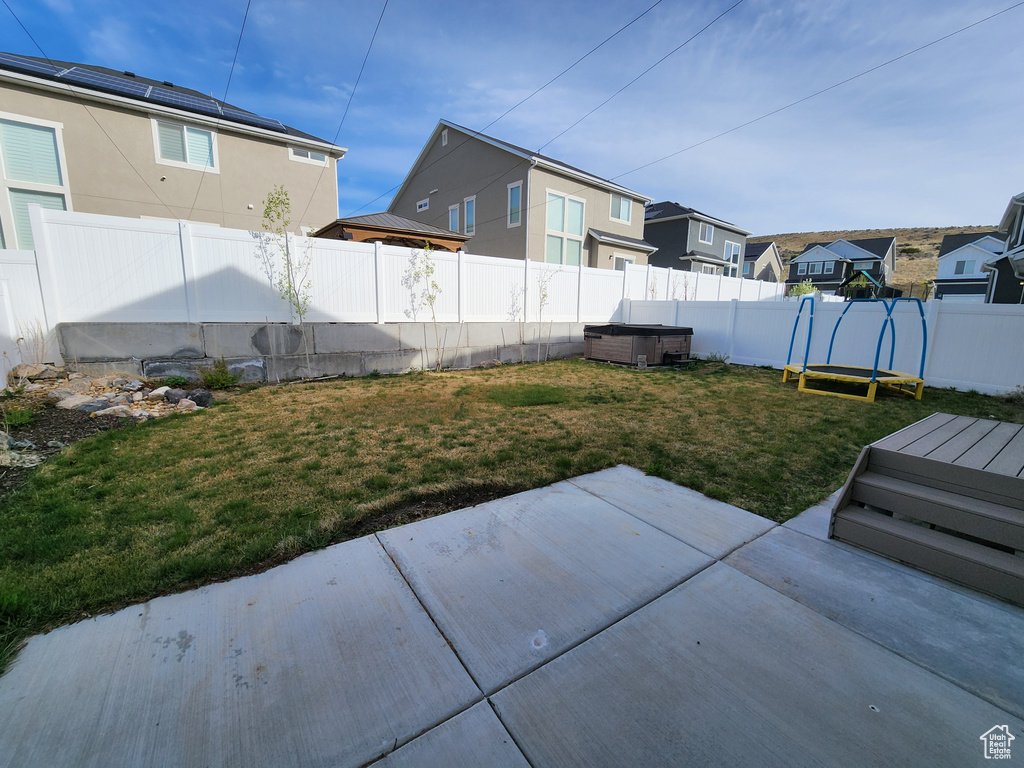 View of yard featuring a patio, a residential view, and a fenced backyard