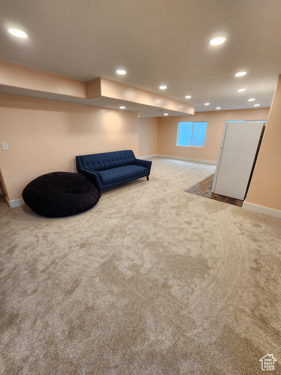 Living area featuring recessed lighting, baseboards, and carpet