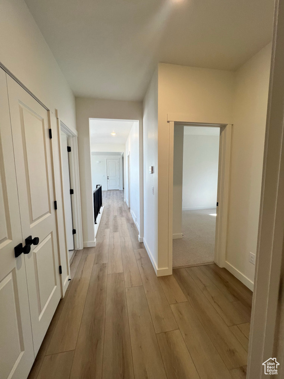 Hallway featuring baseboards and wood finished floors