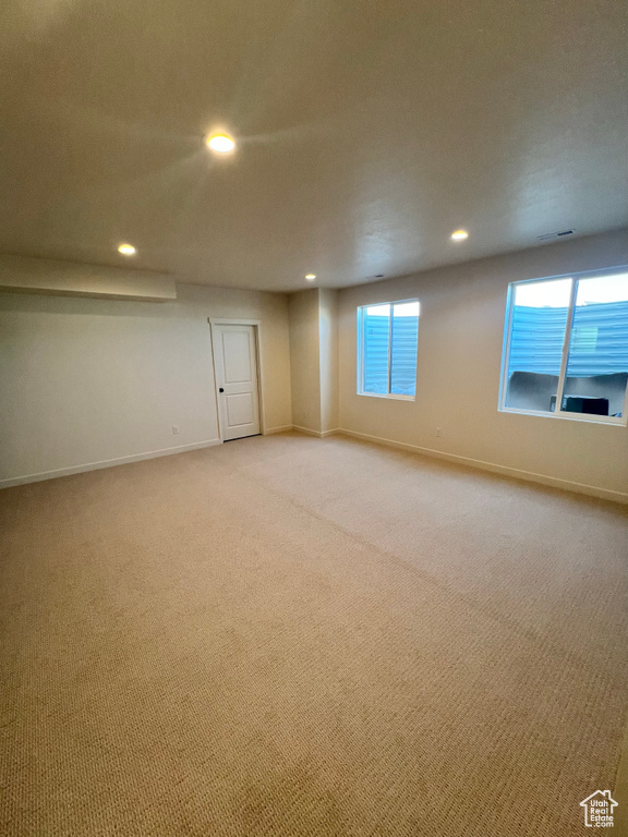 Basement featuring recessed lighting, baseboards, visible vents, and light colored carpet