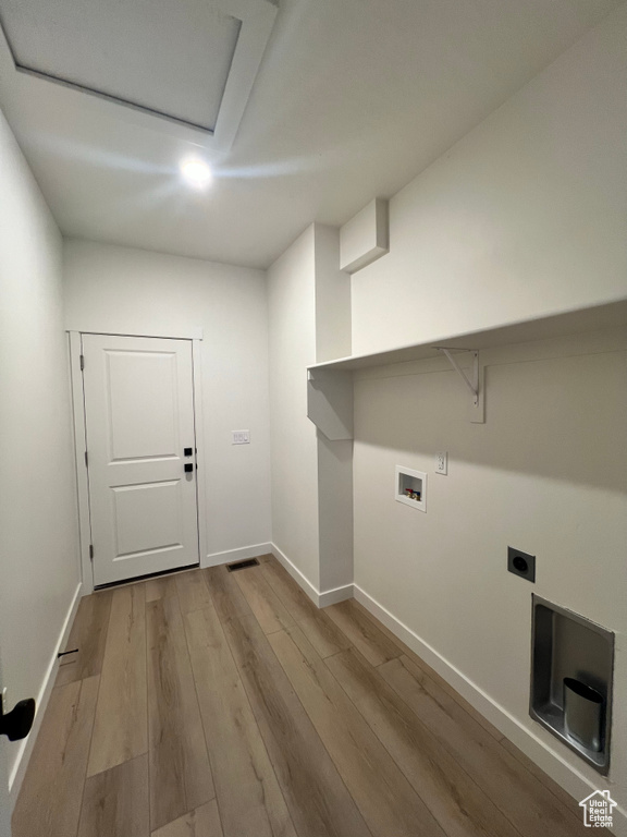 Laundry area featuring laundry area, hookup for a washing machine, baseboards, electric dryer hookup, and wood finished floors