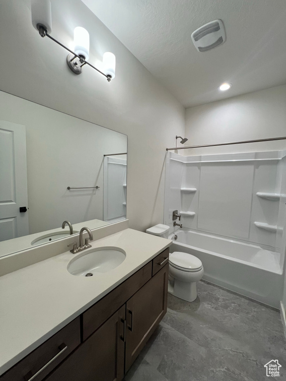 Bathroom featuring vanity, toilet, a textured ceiling, tub / shower combination, and visible vents