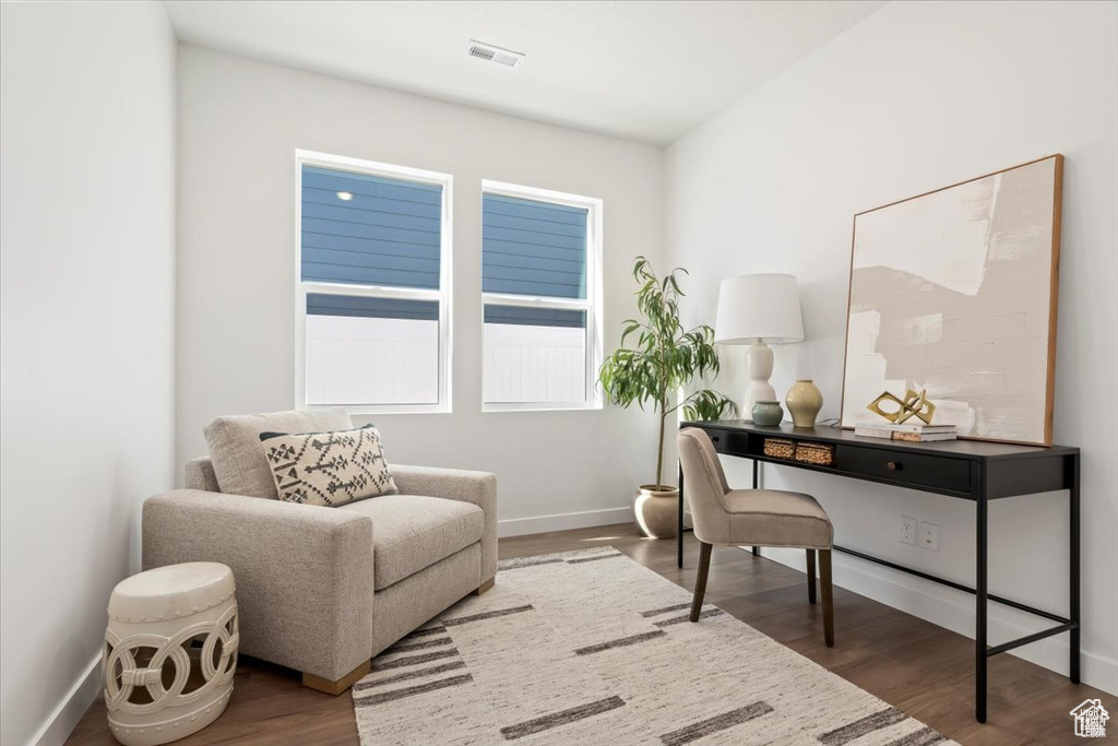 Home office with baseboards, wood finished floors, and visible vents