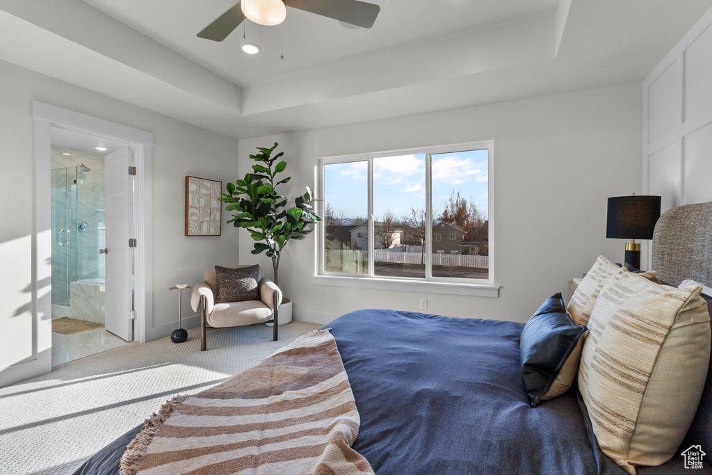 Carpeted bedroom with baseboards, recessed lighting, a raised ceiling, connected bathroom, and a ceiling fan
