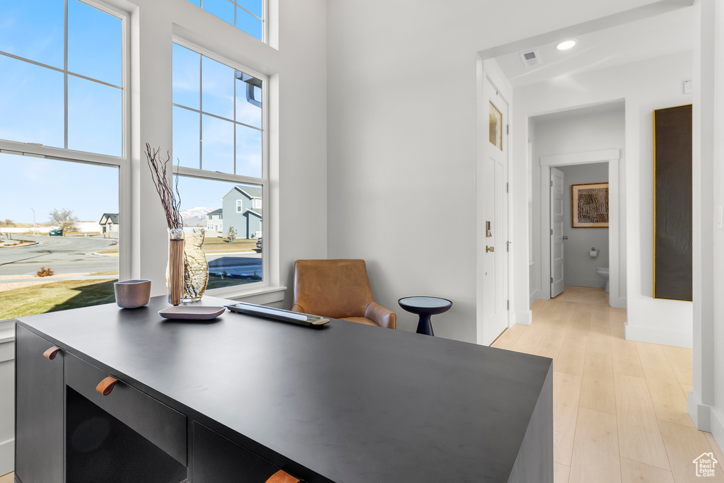 Office area with recessed lighting, baseboards, visible vents, and light wood-style floors