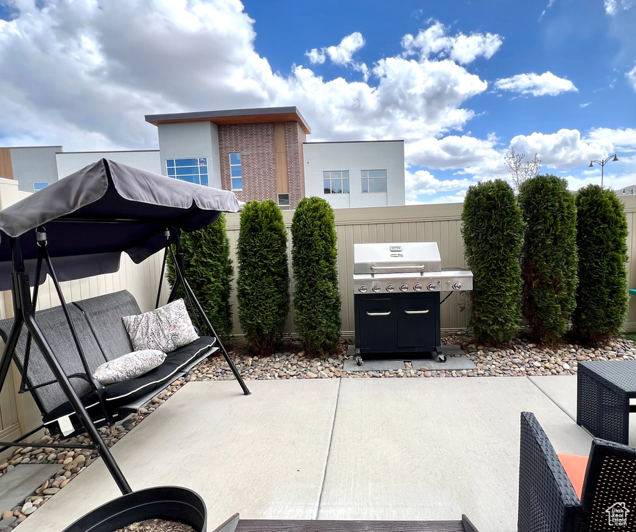 View of patio with grilling area and fence