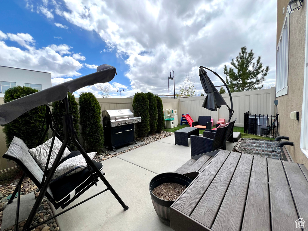 View of patio / terrace with a fenced backyard, an outdoor hangout area, and a grill