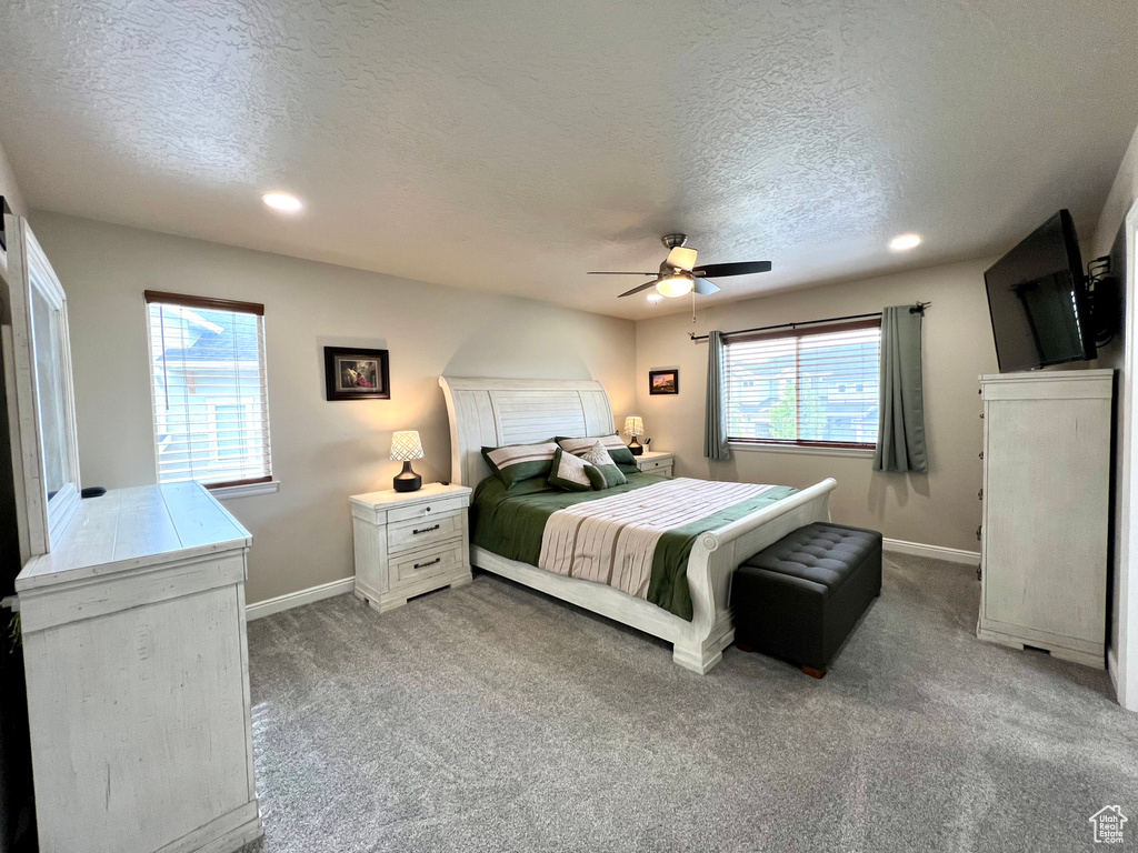 Carpeted bedroom with recessed lighting, a textured ceiling, and baseboards