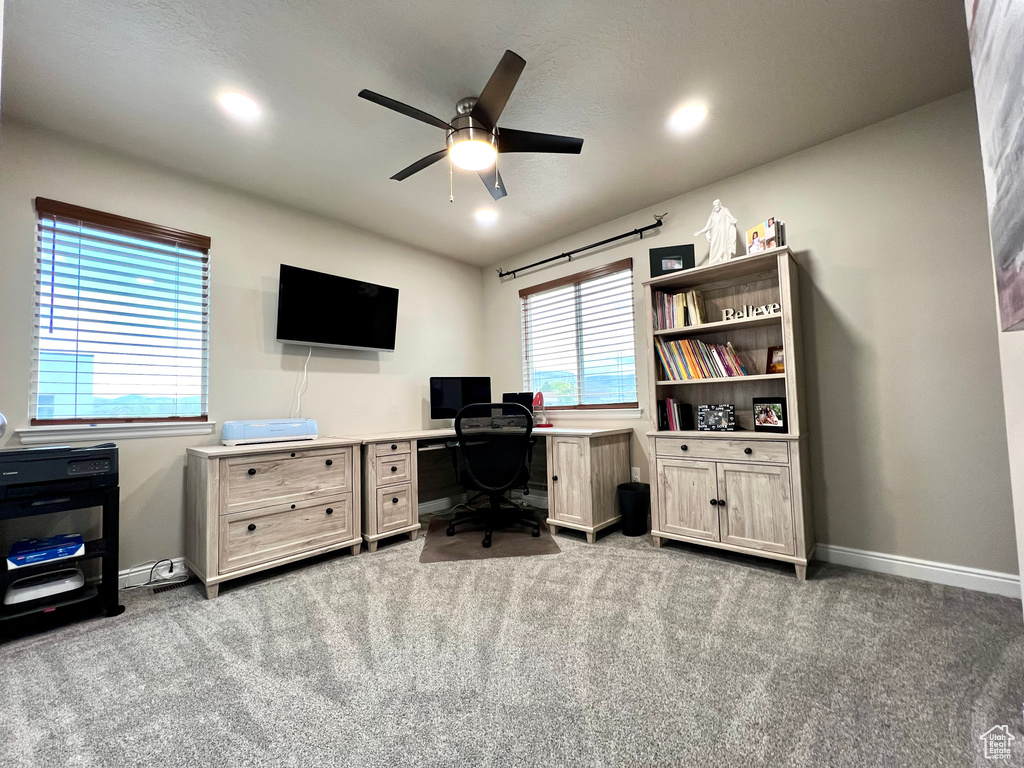 Carpeted office space featuring baseboards, a ceiling fan, and recessed lighting