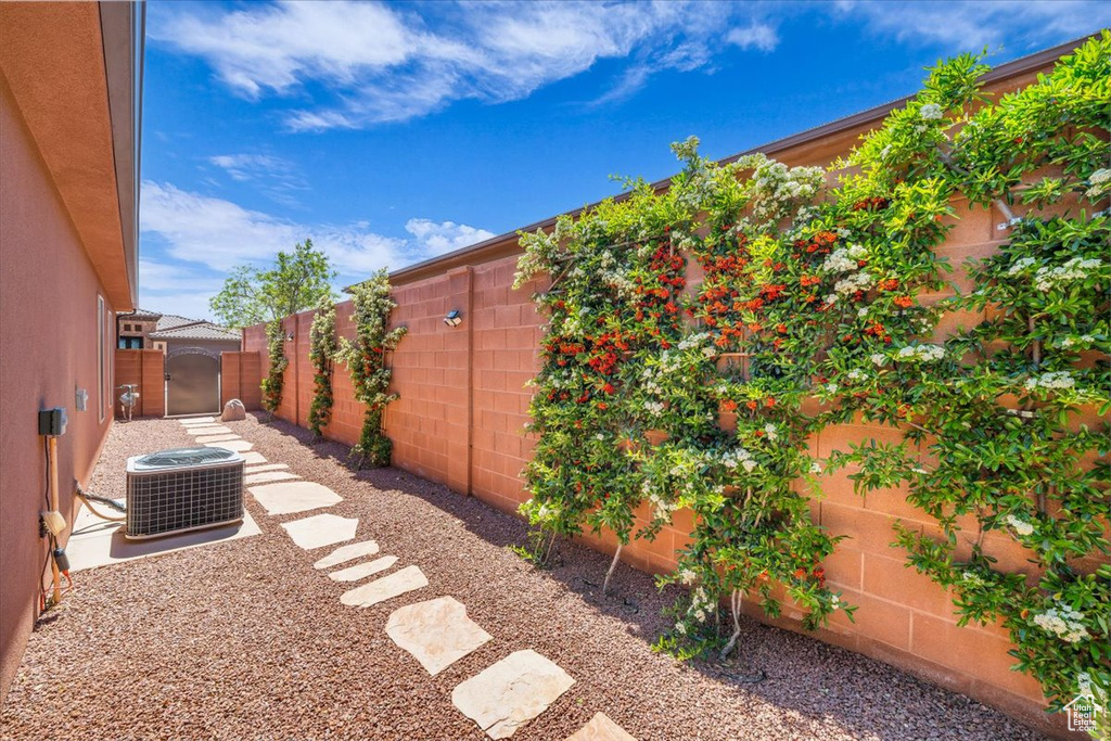 View of yard featuring a fenced backyard and central AC