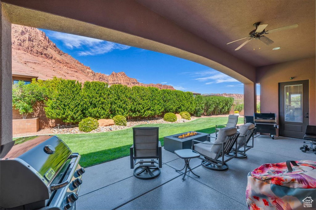 View of patio / terrace featuring ceiling fan, a grill, and a fire pit