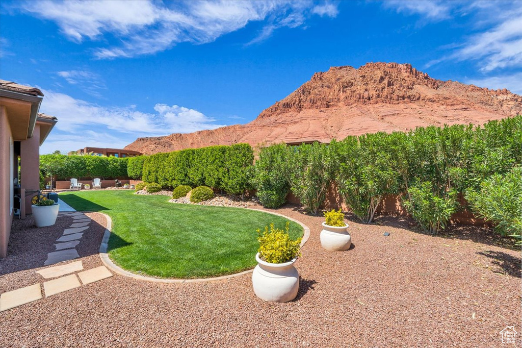 View of yard featuring a mountain view and a fenced backyard
