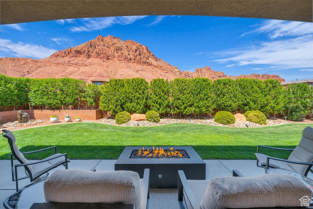 View of patio featuring a mountain view and a fire pit