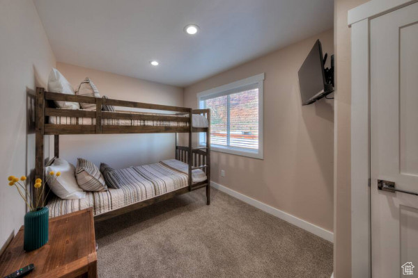 Carpeted bedroom with recessed lighting and baseboards