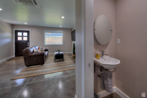 Interior space with visible vents, concrete floors, and baseboards