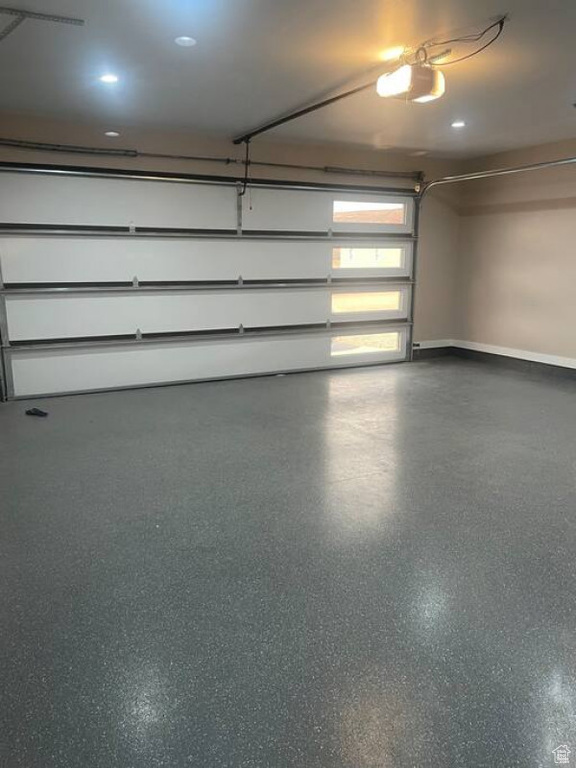 Garage with baseboards and a garage door opener