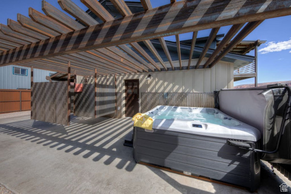 View of patio / terrace featuring a pergola and a hot tub