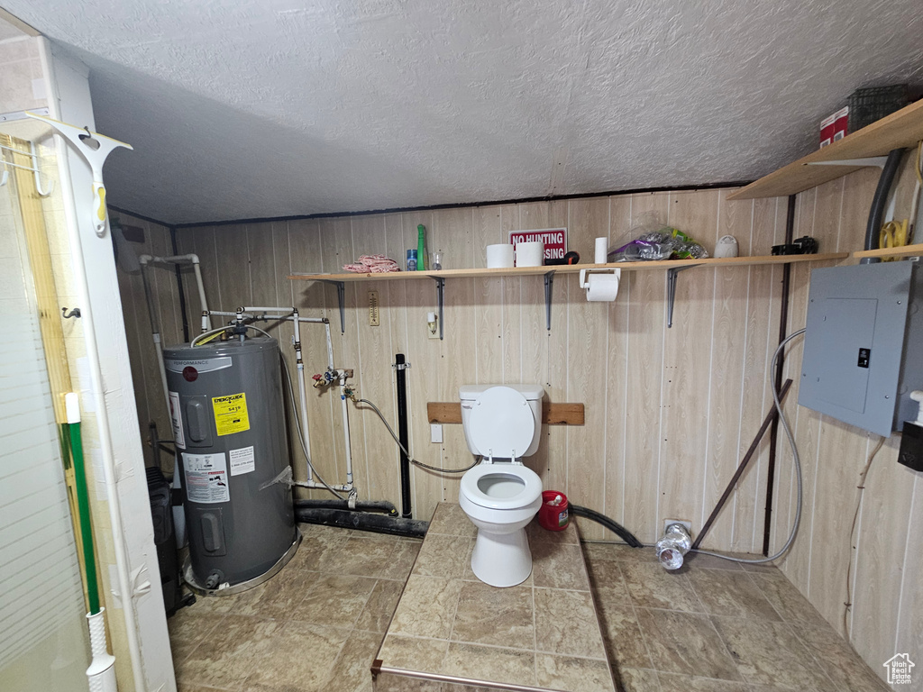 Utility room featuring electric water heater and electric panel