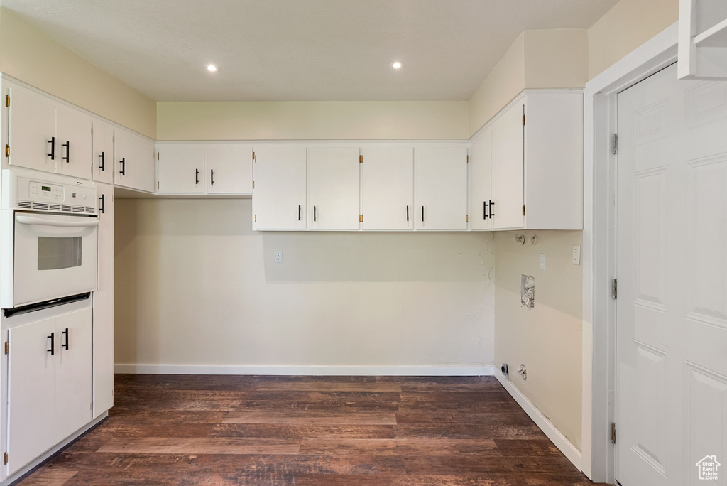 Clothes washing area with recessed lighting, baseboards, and dark wood-style floors
