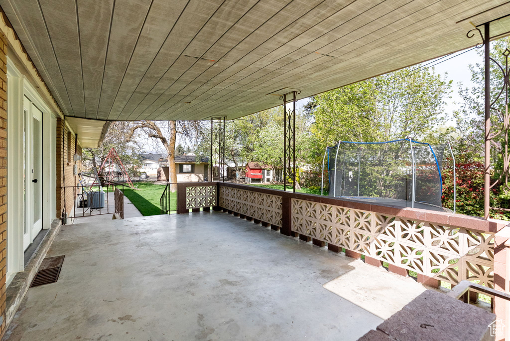 View of patio with a trampoline and visible vents
