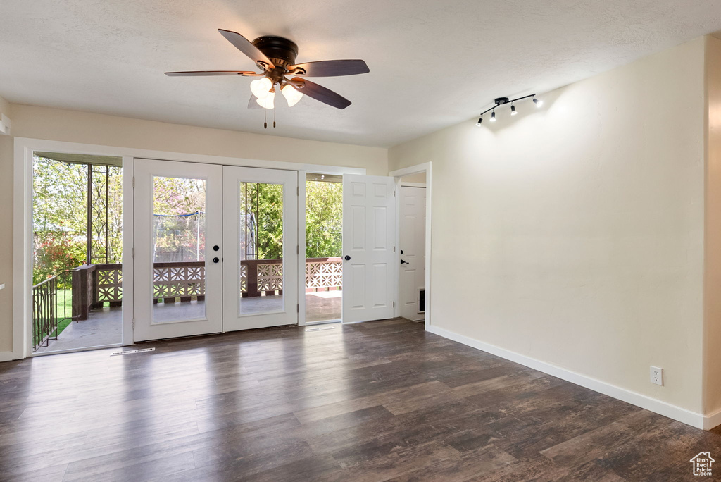 Interior space with baseboards, ceiling fan, and french doors