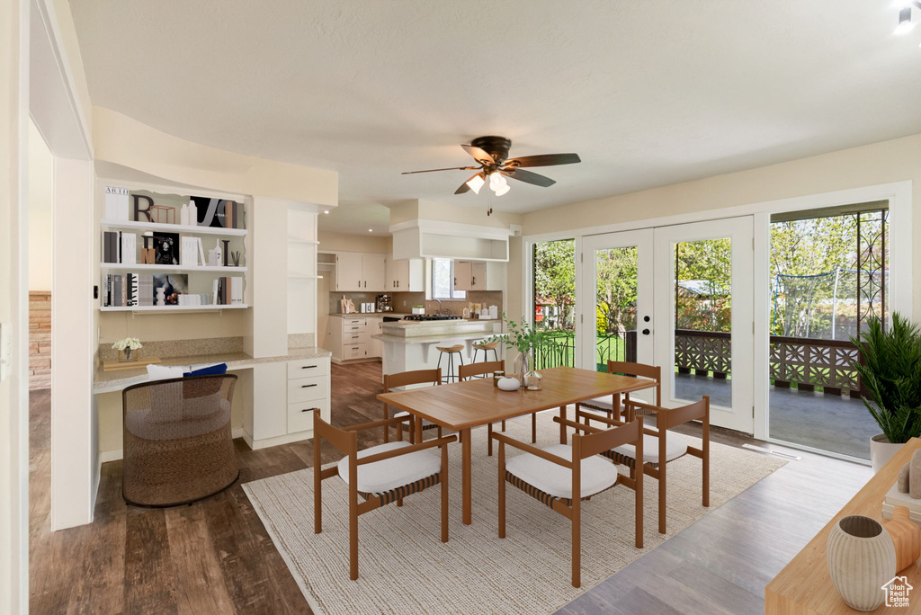 Dining room featuring a ceiling fan, french doors, and dark wood-type flooring
