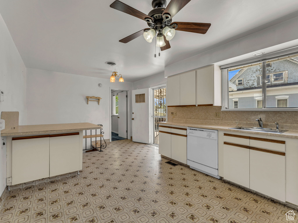 Kitchen with decorative backsplash, ceiling fan, light countertops, a sink, and dishwasher