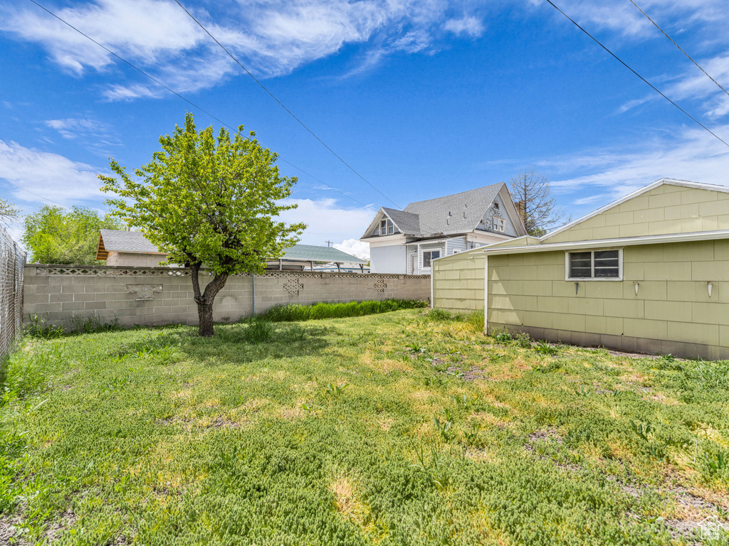 View of yard featuring fence