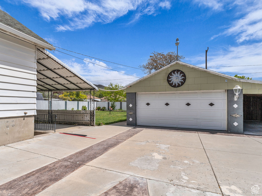 Detached garage featuring fence