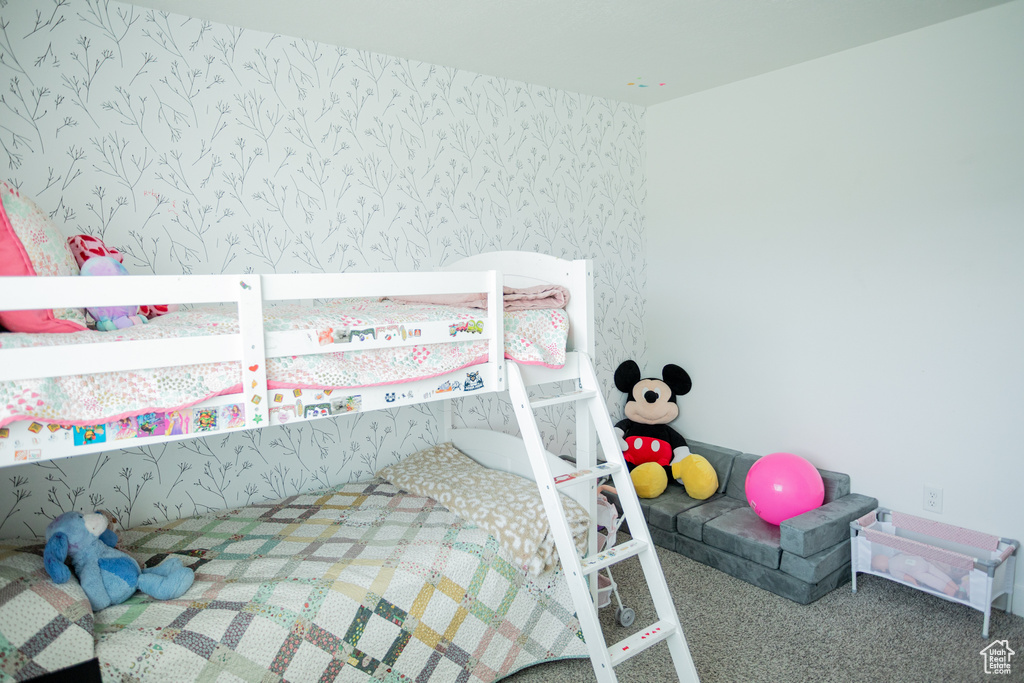 Bedroom featuring carpet flooring and wallpapered walls