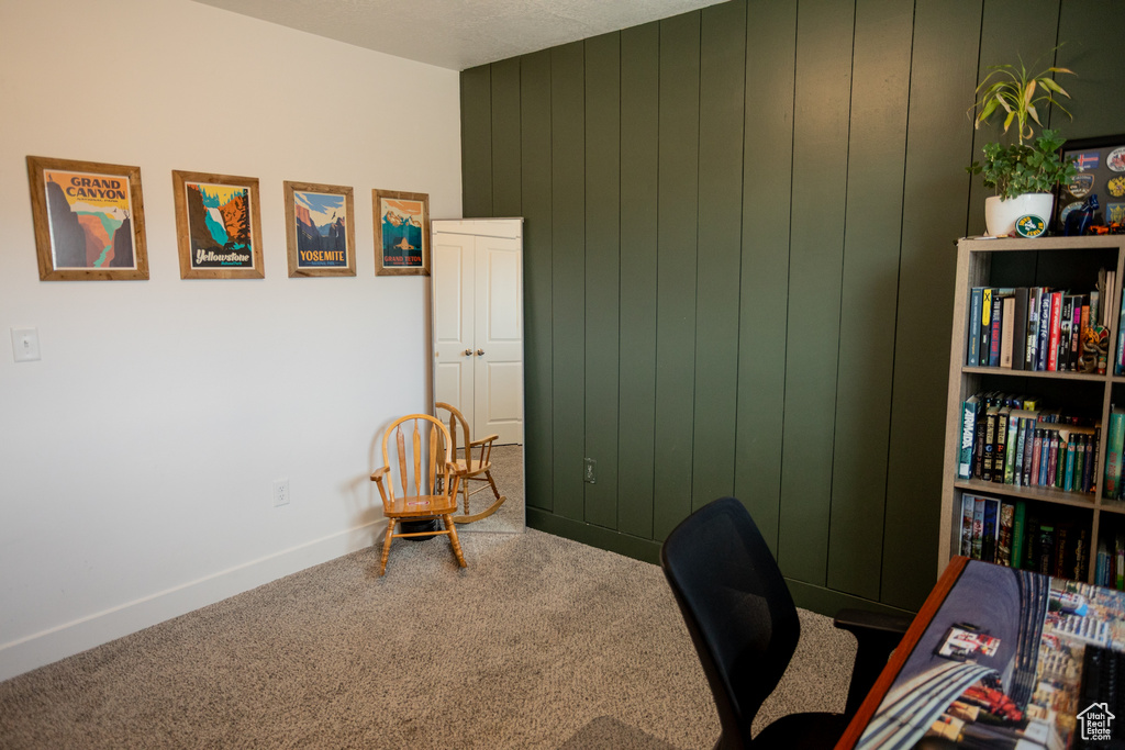 Home office with carpet floors and baseboards
