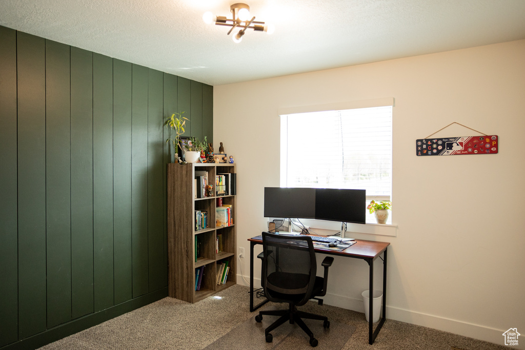 Carpeted office space featuring baseboards