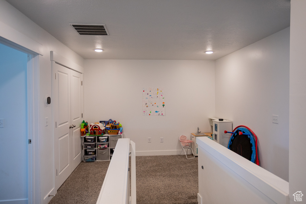 Carpeted bedroom with baseboards and visible vents