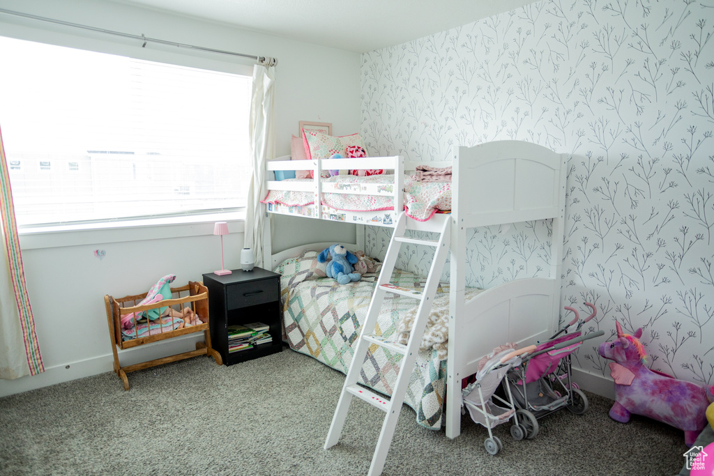 Bedroom featuring carpet floors and wallpapered walls