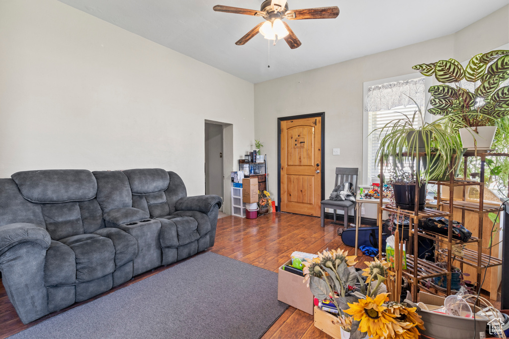 Living area featuring wood-type flooring and a ceiling fan