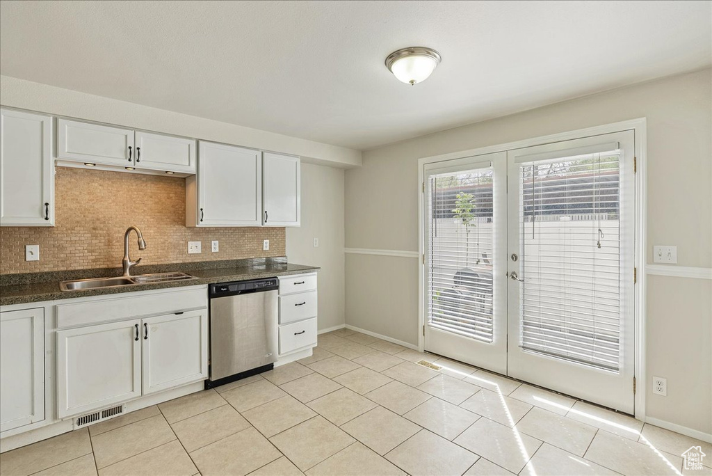 Kitchen with a sink, stainless steel dishwasher, french doors, and visible vents