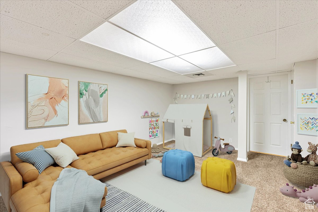 Recreation room featuring carpet floors, a drop ceiling, and visible vents