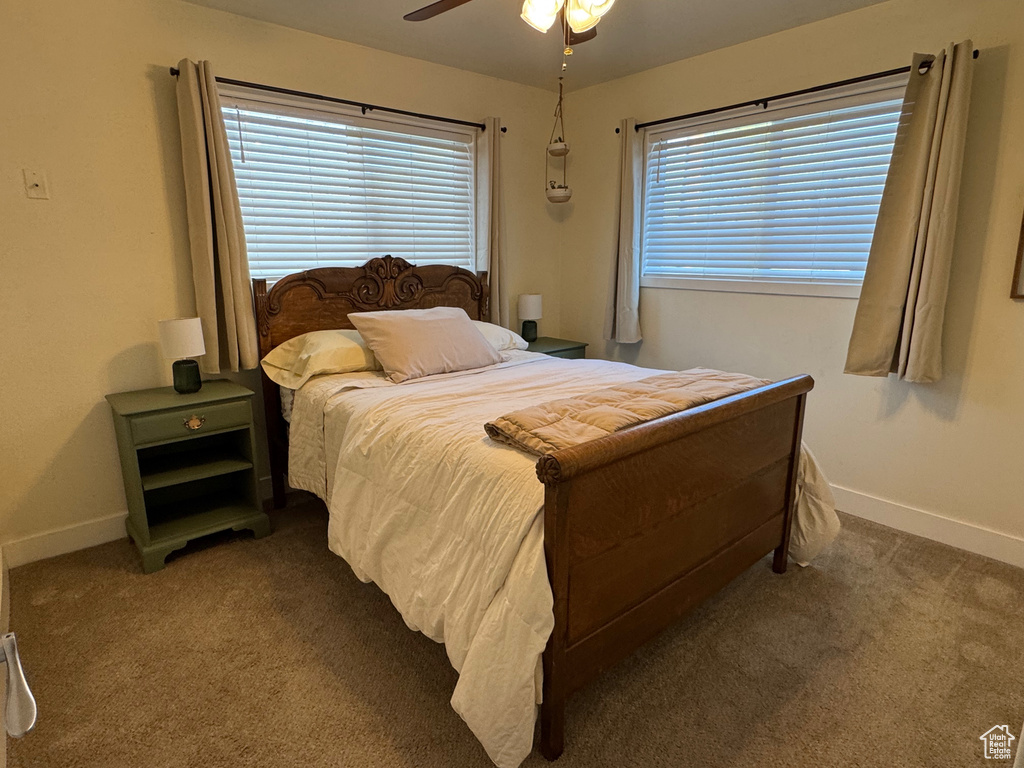 Bedroom with baseboards, carpet, and a ceiling fan