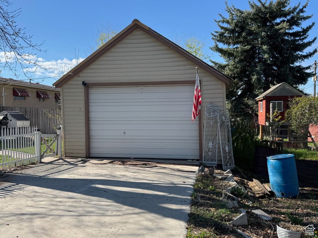 Detached garage featuring fence