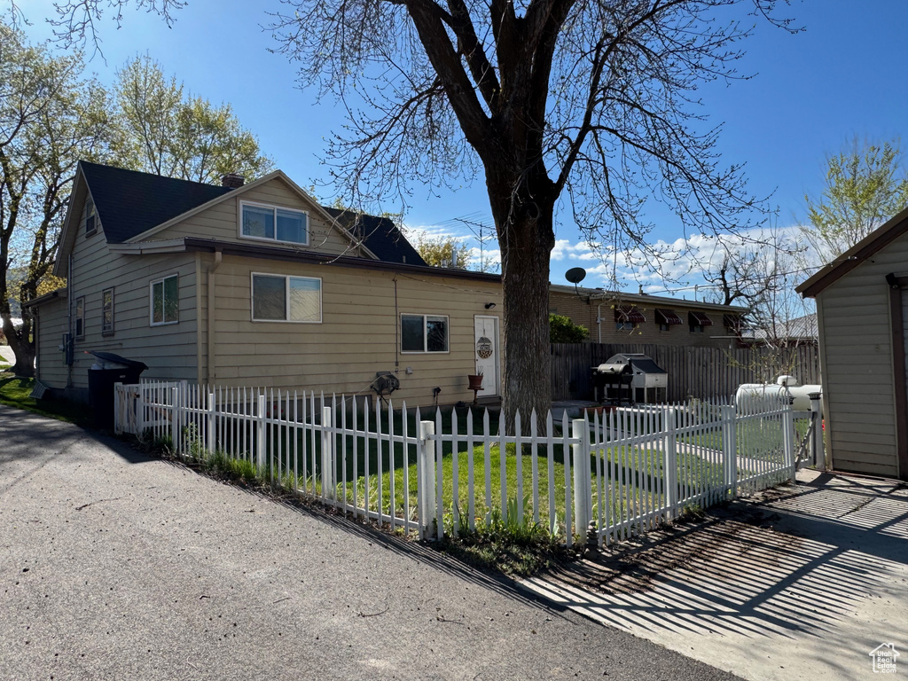 View of front facade with a fenced front yard and a front lawn