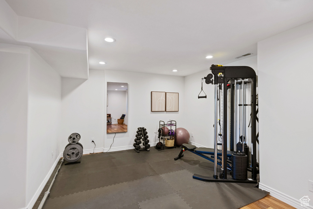 Exercise room with recessed lighting and baseboards