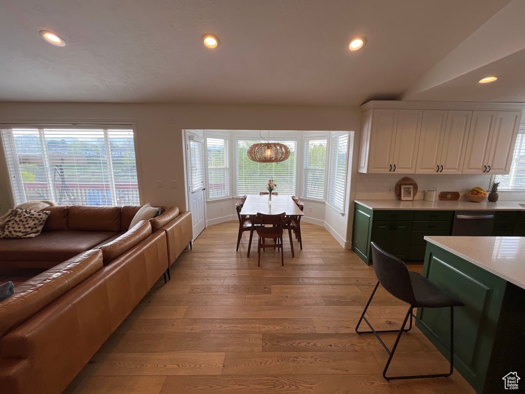 Kitchen featuring dishwasher, light countertops, baseboards, white cabinets, and recessed lighting
